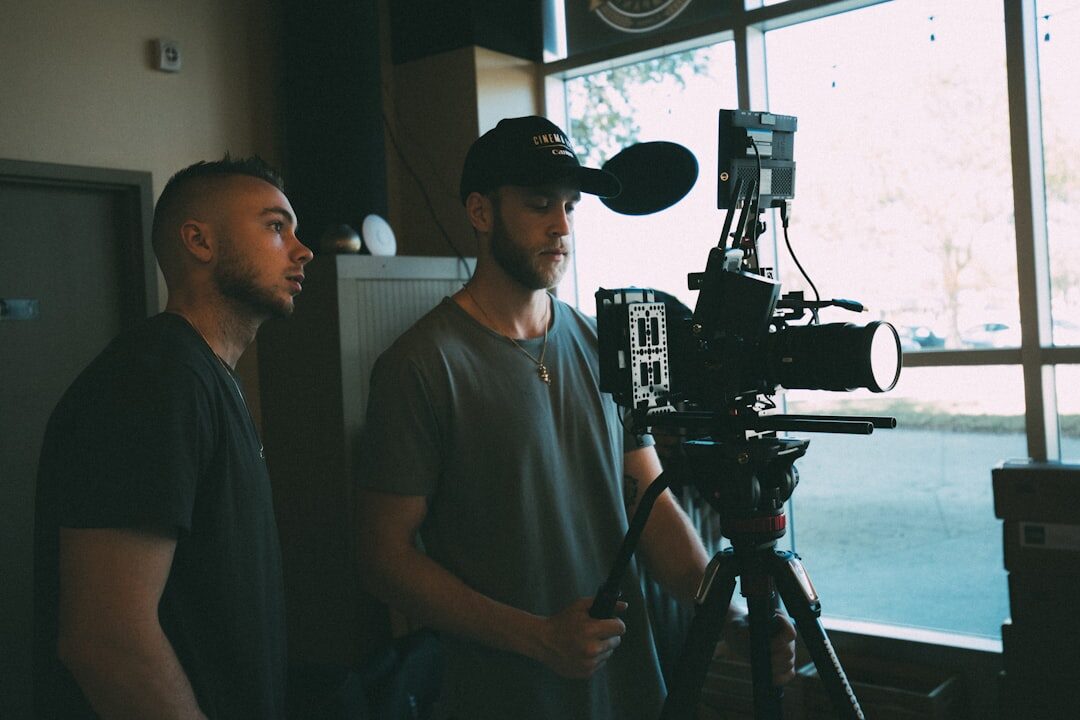 Professional camera operator positioning broadcast camera on set