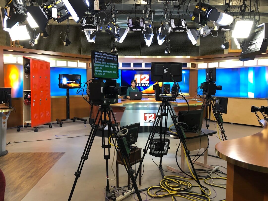 Professional broadcast studio with colorful lighting and cameras
